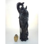 A Chinese carved wooden figure of of deity standing on a naturalistic base,