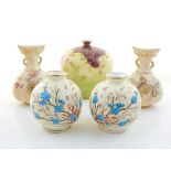 A pair of Worcester vases of bag form, decorated with flowers on a blush ground,