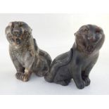 A pair of marble figurines, modelled as roaring tigers.