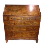 A George III oak bureau with moulded fall front over an arrangement of six drawers, on bracket feet.