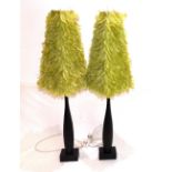 A pair of ebonised contemporary table lamps, Orla Collins, green layered feather shades. H.