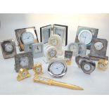 Two contemporary silver framed bedside clocks, and a quantity of modern travel and study clocks.