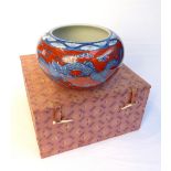 Chinese contemporary bowl, red glaze with blue open mouth dragons chasing a flaming pearl,