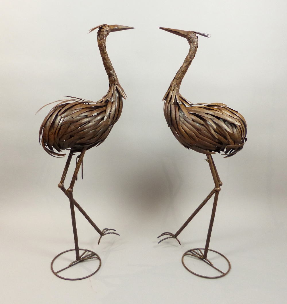 Pair of contemporary bronzed strip metal ornaments of standing cranes, H.