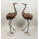 Pair of contemporary bronzed strip metal ornaments of standing cranes, H.