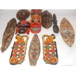 A Sri Lankan polychrome decorated wooden figurine, flanked by immortals,