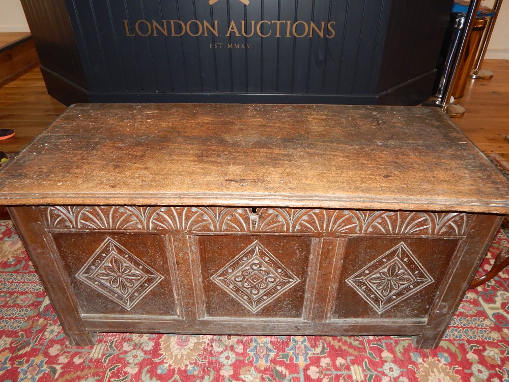 18th century design oak coffer, with lozenge carved triple panel front, on stile feet. W.