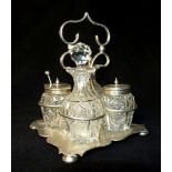 Hallmarked silver cruet stand with cut glass condiment containers,