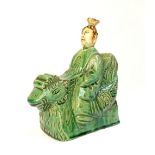 Chinese roof finial, study of a man sitting on a green glaze chicken,