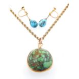 Turquoise pendant orb on a 9ct gold open rope twist chain,