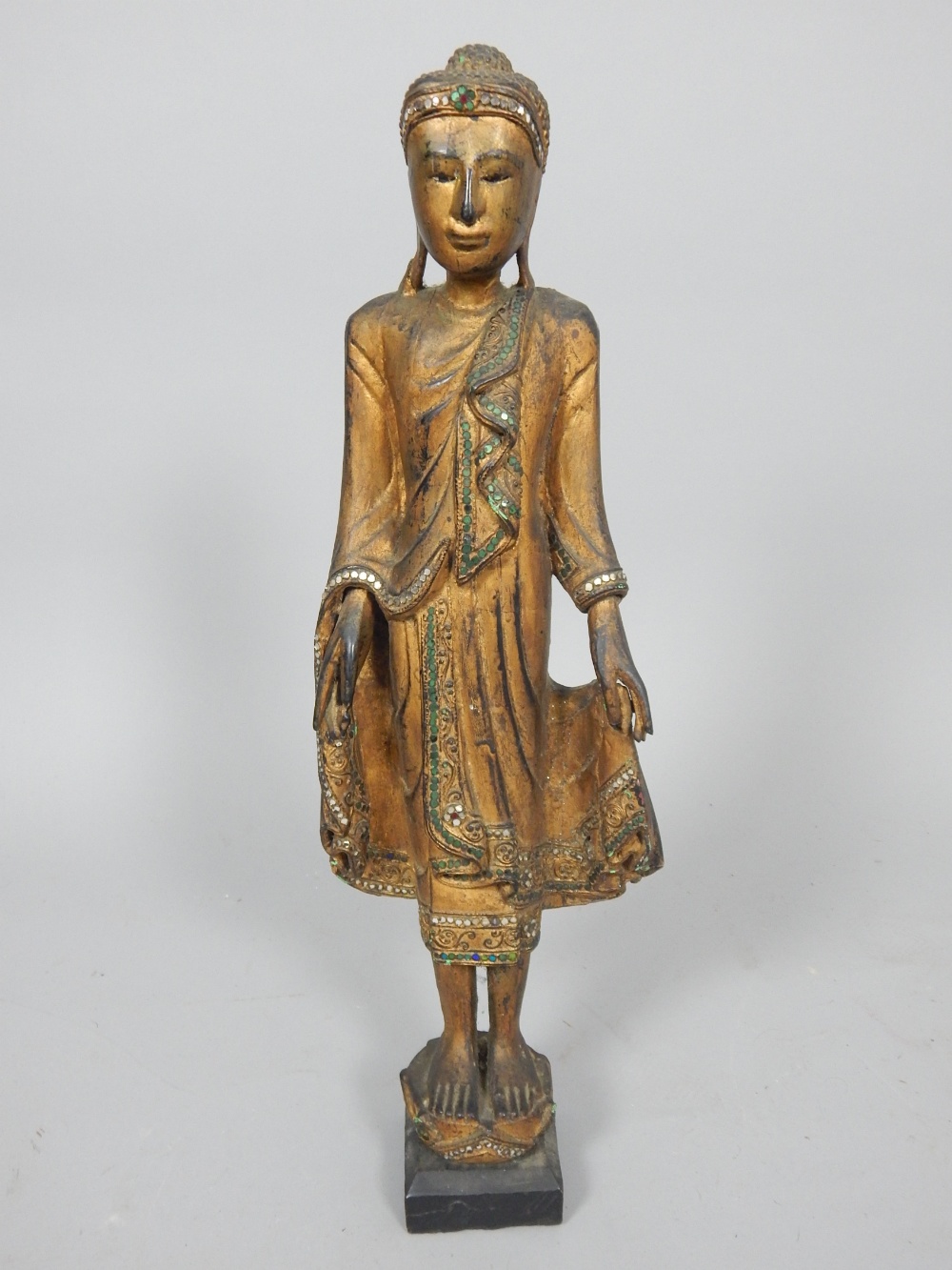 Carved study of Buddha, gilded and jewelled, c.