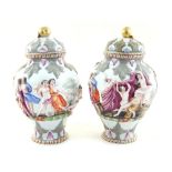 A pair of late 19th century Capodimonte style baluster vases with covers, the continuous low