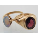 Opal dress ring, the oval stone set in a yellow metal band marked 9ct, a smokey topaz dress ring