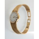 Ladies Omega wristwatch, silvered dial with baton numerals, within a 9ct gold case and textured