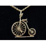 9ct gold pendant in the form of a penny-farthing bicycle, on a 9ct gold chain, 11g