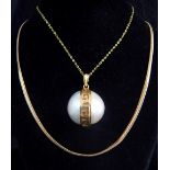 Double mabe pearl pendant in gold mount with Greek key design,