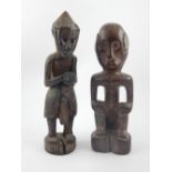 Pair of primitive antique carved tribal wooden figures;