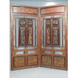 Early 20th century Chinese red lacquer and gilded two fold screen,