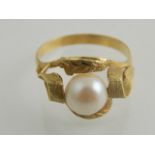 Gold ring set with a pearl, in textured leaf mount, possibly French marks,