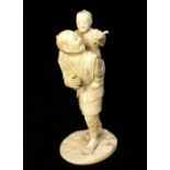 Late 19th C Japanese carved ivory group of a fisherman carrying his son who is holding a crab,