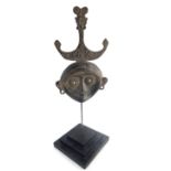 Timor Island tribal metal mask of stylised form with pierced eye holes, ears,