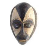 Fang secret society tribal face mask, carved wood with white heightened detail,