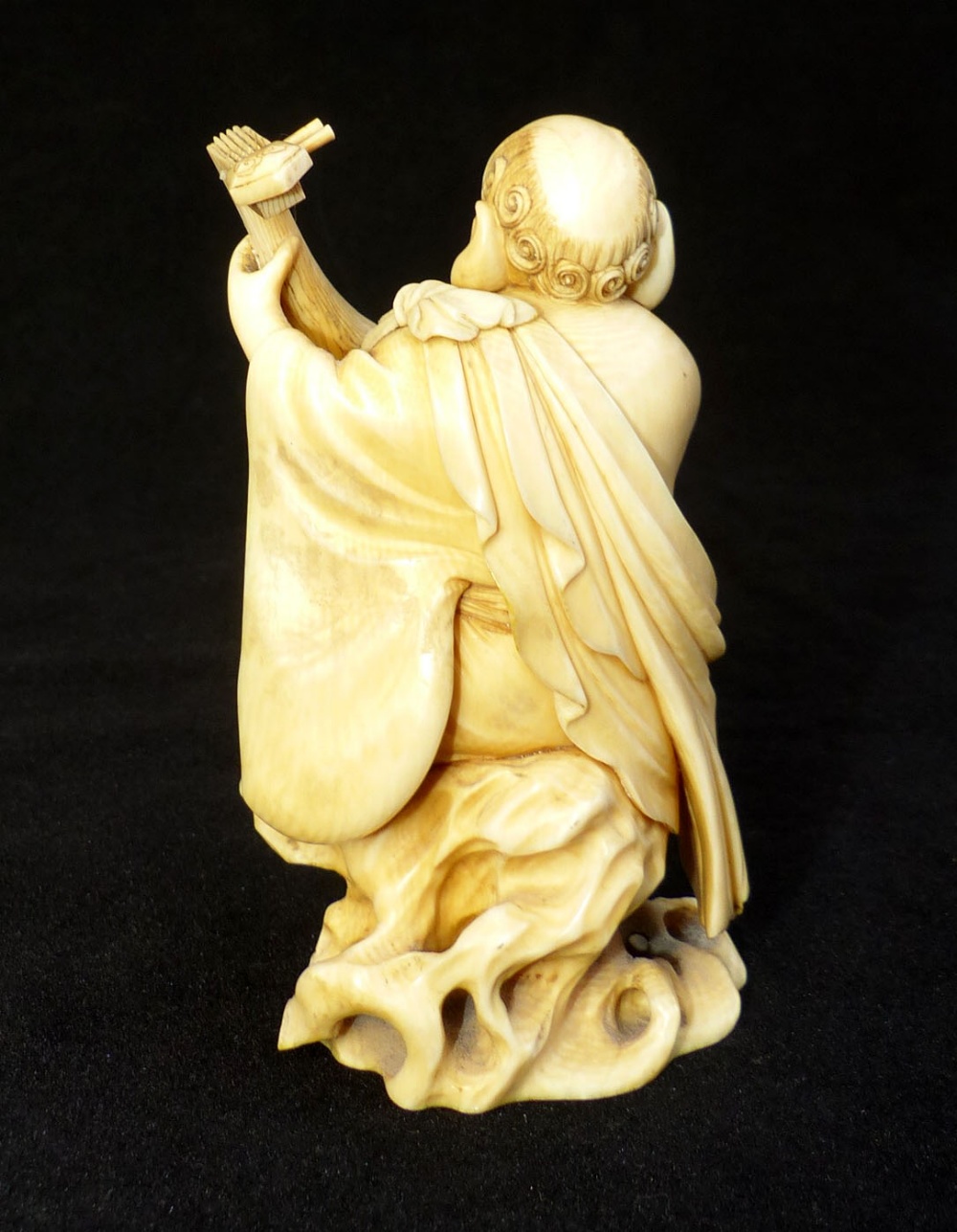 A19th C carved ivory okimono of a plump monk strumming a lute, signed in red seal to base, - Image 3 of 4