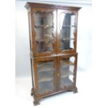 George II design walnut glass cabinet, enclosed by four moulded shaped doors,