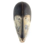 Iconic antique Ngi secret society tribal face mask, carved wood with white pigmentation,