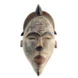 Very elegant antique Nigerian female spirit mask with red and white pigment,