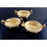 Trio of silver gilt salt dishes of Rococo design,