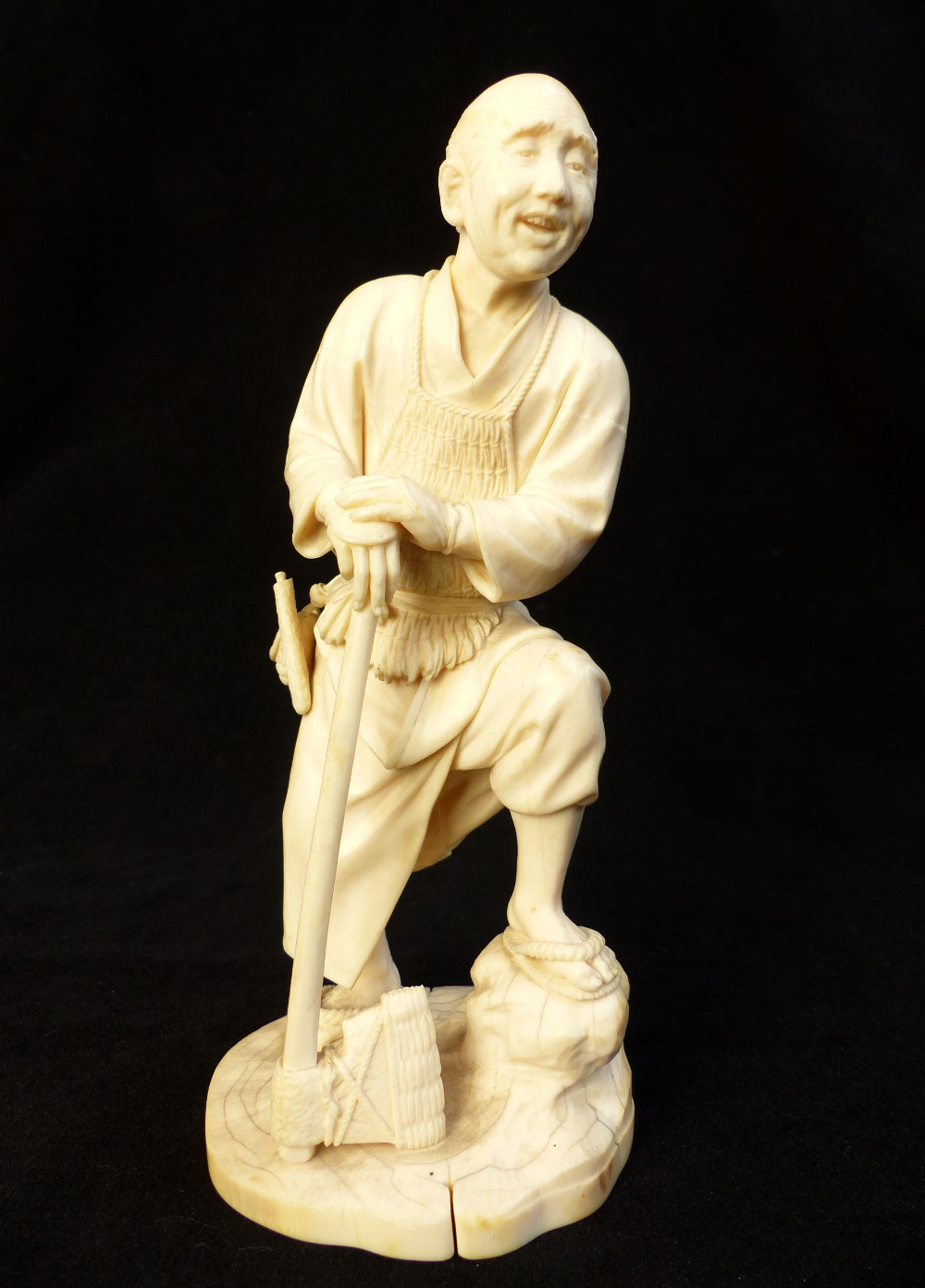 Fine 19th C Japanese carved ivory okimono of a woodsman leaning on his axe, signed to base, 20.