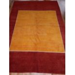Moroccan rug, originally designed for Dalai Lama by Richard Morant, yellow ground within red border,