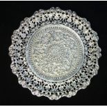 Indian white metal card tray of pierced circular form, embossed with flower heads, 15cm dia.