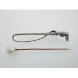 Stock pin in form of riding crop, stamped 925, and a tie pin set with a baroque pearl,