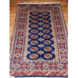 Pakistani rug, elephant pad medallions on blue ground, reticulated borders, fringed,