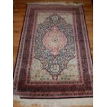 Indian part silk rug, decorated with floral sprandrels and central tear drop medallion,