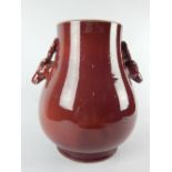 Chinese sang de boeuf baluster shape vase with twin stag head handles,
