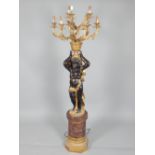 Electrolier cast in the form of a blackamoor, supporting a nine branch light above his head,