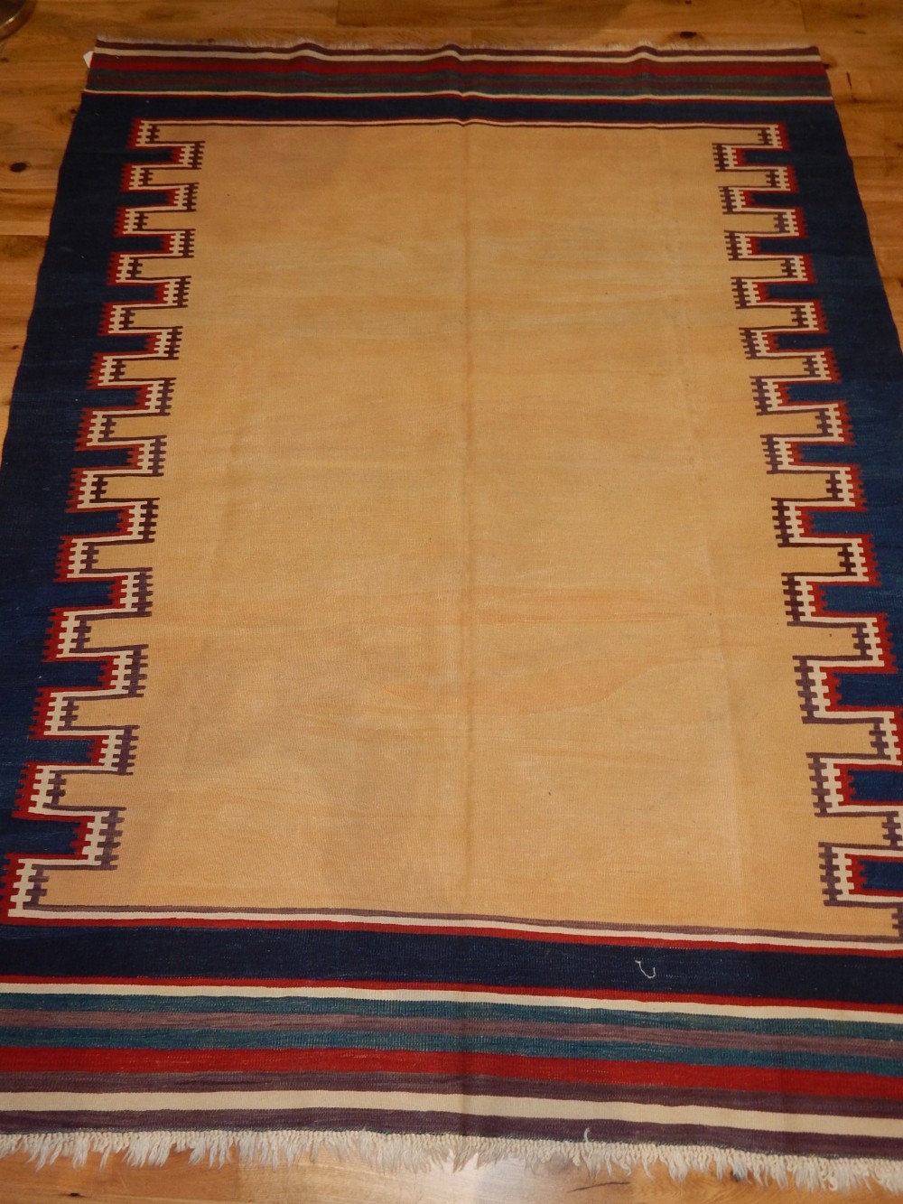 Fethiye kelim rug, centre yellow ground, within blue geometric border,