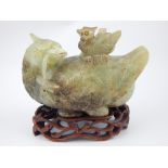 Chinese green hardstone model of bird, raised on hardwood carved stand, 18cm h,