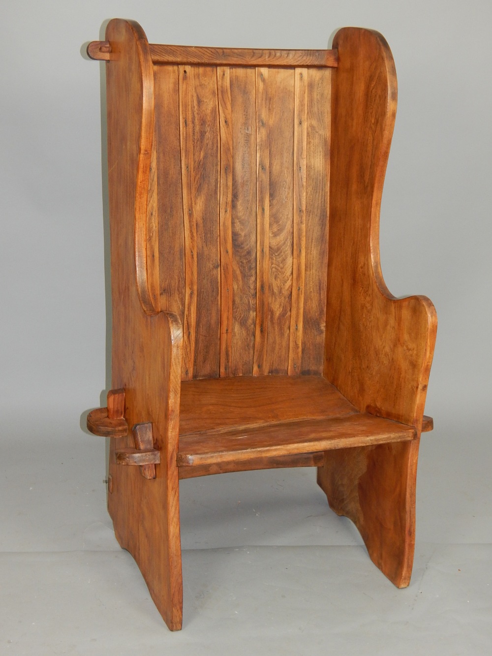 Elm lambing or porters chair, with panelled back and shaped solid sides of wedged construction,