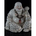 Chinese ceramic seated Buddha, wearing floral garment and holding a ruyi scepter, gilt heightened,