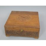 Chinese carved hardwood box, the hinged cover decorated with Peony over a dragon and pearl frieze,