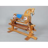 20th century rocking horse, with painted decoration and a platted rope mane and tail,