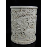 Chinese blanc de chine brush pot, decorated with temple lions playing with an embroidered ball,