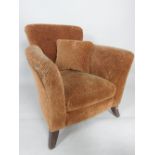 A contemporary tub chair, upholstered in a leopard style print,