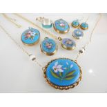 Selection of various gold and yellow metal mounted painted porcelain enamelled pendants,