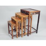 Nest of four Oriental tables, rectangular panelled tops above a pierced frieze,