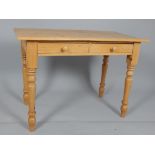 Victorian style pine two drawer side table, on turned tapered legs,